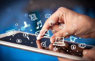 person holding silver tablet computer