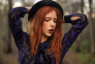 woman wearing blue and black plaid sport shirt with black hat during daytime HD wallpaper