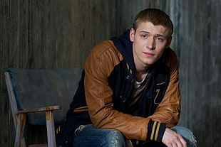 man in brown and blue letterman jacket