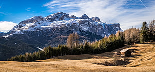 brown house near hill under blue skies, corvara, alta badia