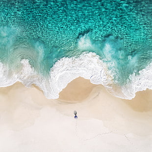 person near ocean wave during daytime