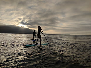 blue surfboard, sky, sea, standing, sunset HD wallpaper