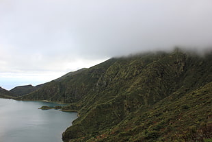 mountain beside a body of water under grey clouds, lagoa, fogo, azores, portugal HD wallpaper