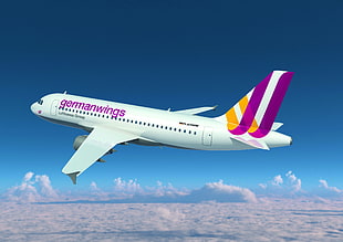 white and purple Germanwings airliner flying