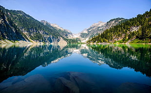 lake in between mountains during daytime HD wallpaper