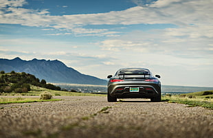 gray sports car on brown road under gray sky during daytime HD wallpaper