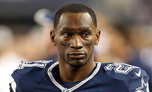 selective focus photography of man wearing blue Nike football jersey