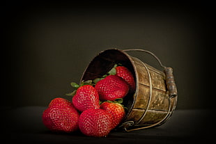 red strawberries in brown bucket