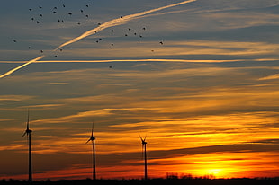 three wind mills during golden hour