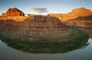 landscape photography of rock formation surrounded by river during datyime