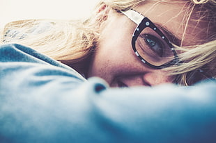 close up photo of woman wearing black eyeglasses