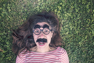 woman wearing mustache disguise