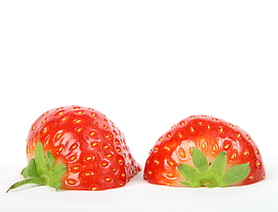 two red sliced strawberries on white surface HD wallpaper