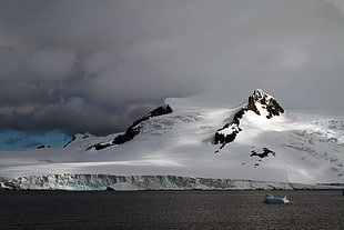 snowy mountain under clear cloudy sky during daytime