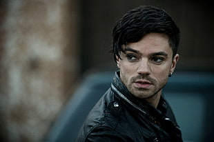 close up photo of black haired man wearing black jacket