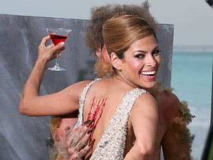 woman holding clear martini glass