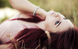 woman lying on green grass field photography HD wallpaper