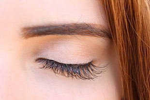 close up photo of woman closed eye