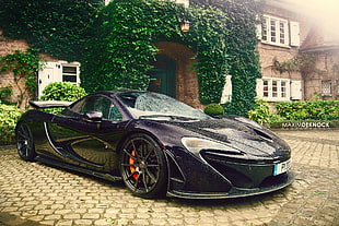 black sports car parked near gray stone building