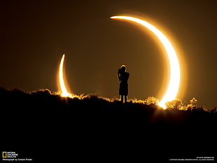 silhouette of a person standing on cloud next to moon illustration