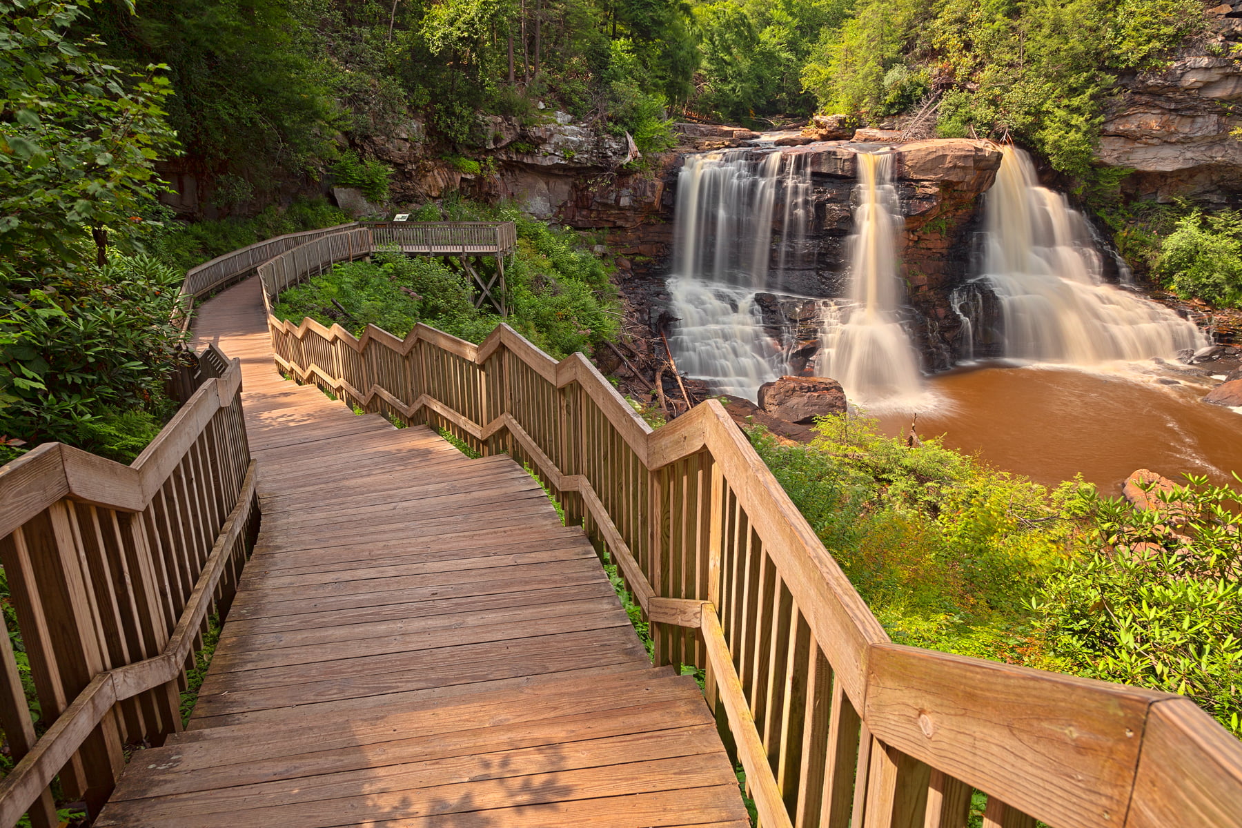 brown wooden stairway near water falls, blackwater falls