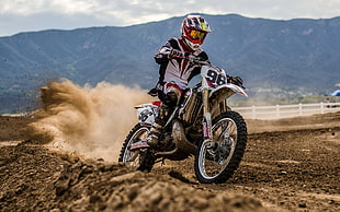 person riding motocross dirt bike on track during daytime HD wallpaper