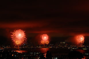 red fireworks and city buildings HD wallpaper