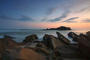 Rocks on Beach at Sunset HD wallpaper