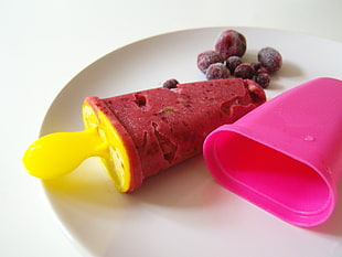 red and yellow popcicle ice cream on white plate HD wallpaper