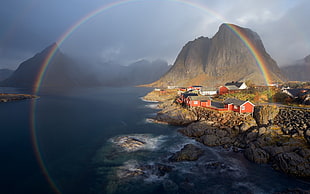 village near mountain and ocean with rainbow in between, nature, landscape, water, trees HD wallpaper