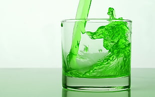 clear shot glass with green liquid HD wallpaper