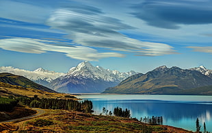 white and green mountains under cloudy clouds