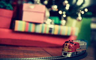red and gray toy train on brown wooden surface HD wallpaper