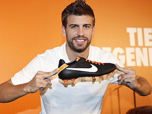 man holding black Nike cleat