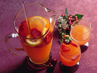 clear glass pitcher with orange juice