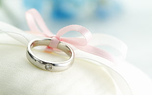 close-up photography of silver-colored diamond encrusted ring