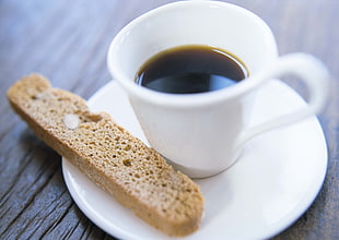 brown bread beside white ceramic cup with black liquid inside HD wallpaper
