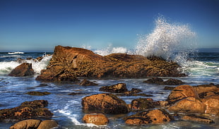 sea wave splashing on brown rock during daytime HD wallpaper