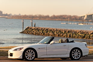 white convertible coupe parking near body of water HD wallpaper