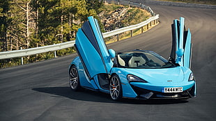 photo of blue coupe with doors open