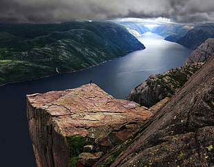 brown rock formation, river, clouds, mountains, rocks