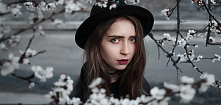 woman under white petal flower tree