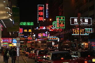 vehicles on road near people walking on side walk and buildings with neon signage, Hong Kong, night, urban, traffic HD wallpaper