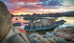 body of water surrounded by rock formation