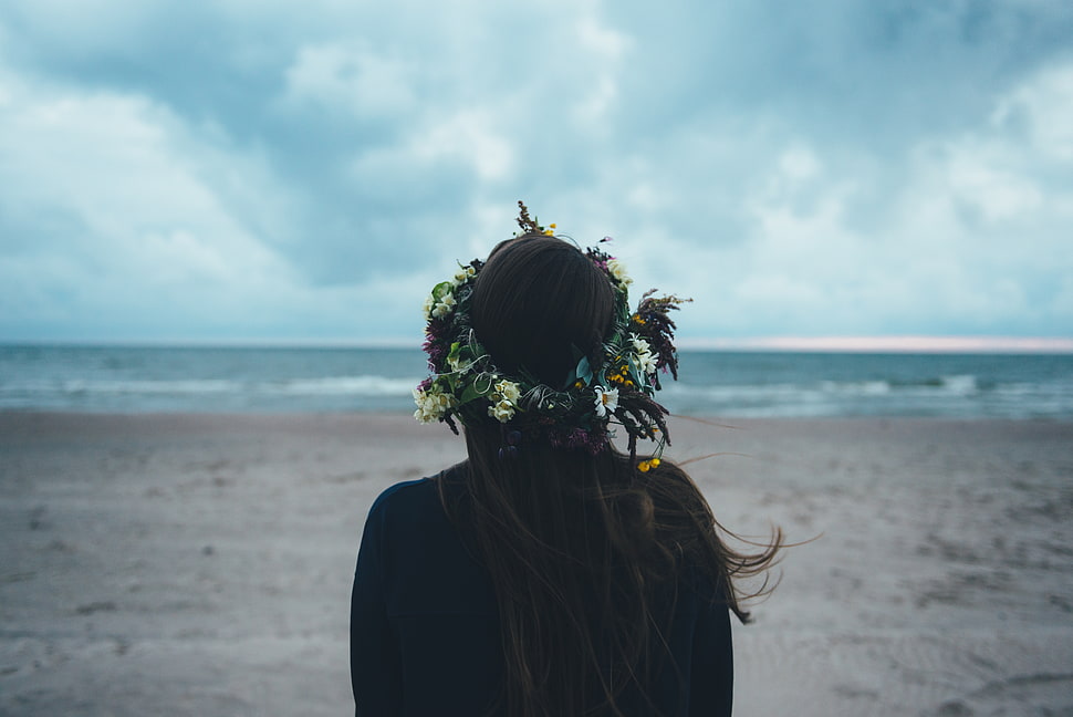 woman standing in front of ocean under nimbostratus clouds HD wallpaper