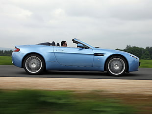 man driving blue convertible coupe on concrete road during daytime HD wallpaper