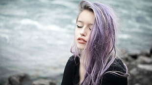 purple hair woman siting beside river