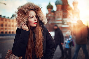 women's brown fur-lined black hooded coat, model, women, redhead, red lipstick
