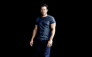 man wearing black shirt on black background