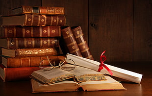 pile of brown hardbound books, books, ribbon, paper, glasses HD wallpaper